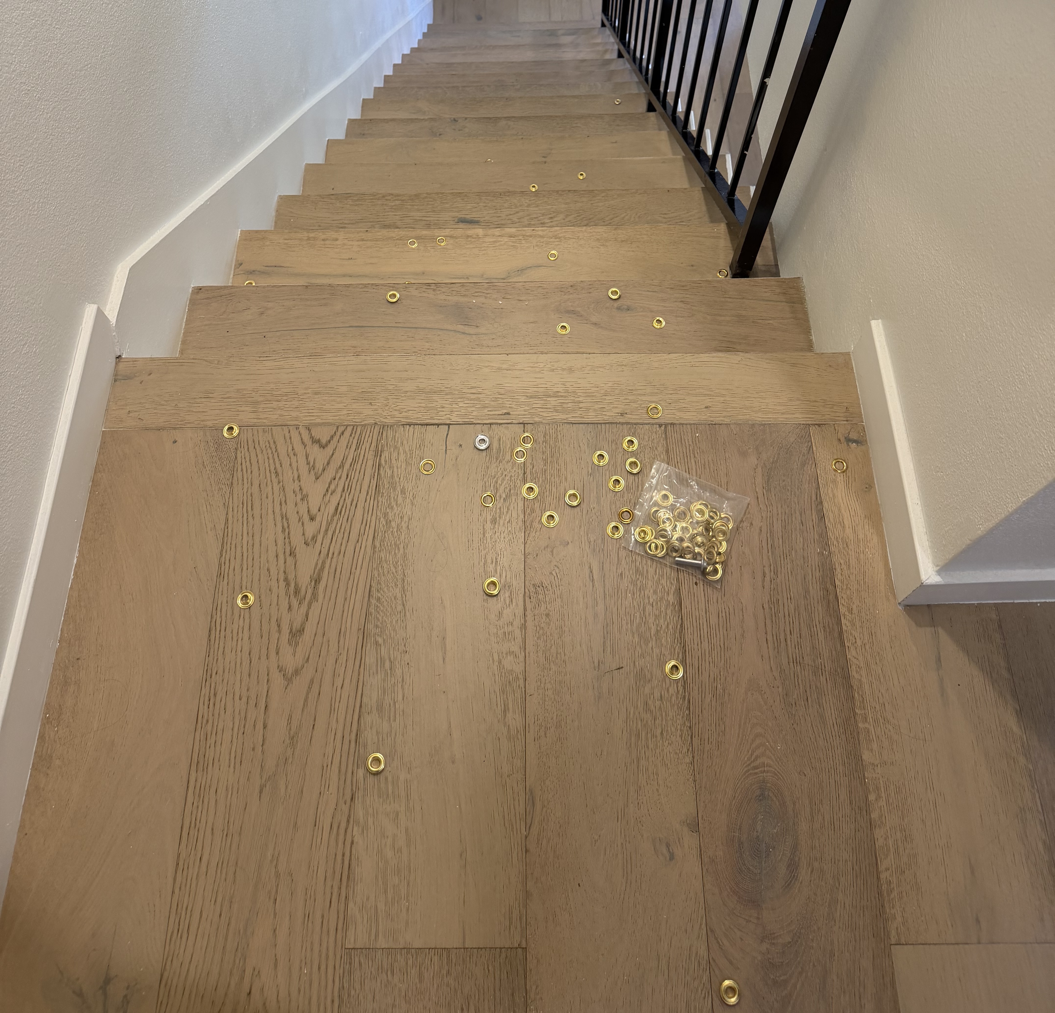 A bag of gold grommets spilled and scattered down the stairs